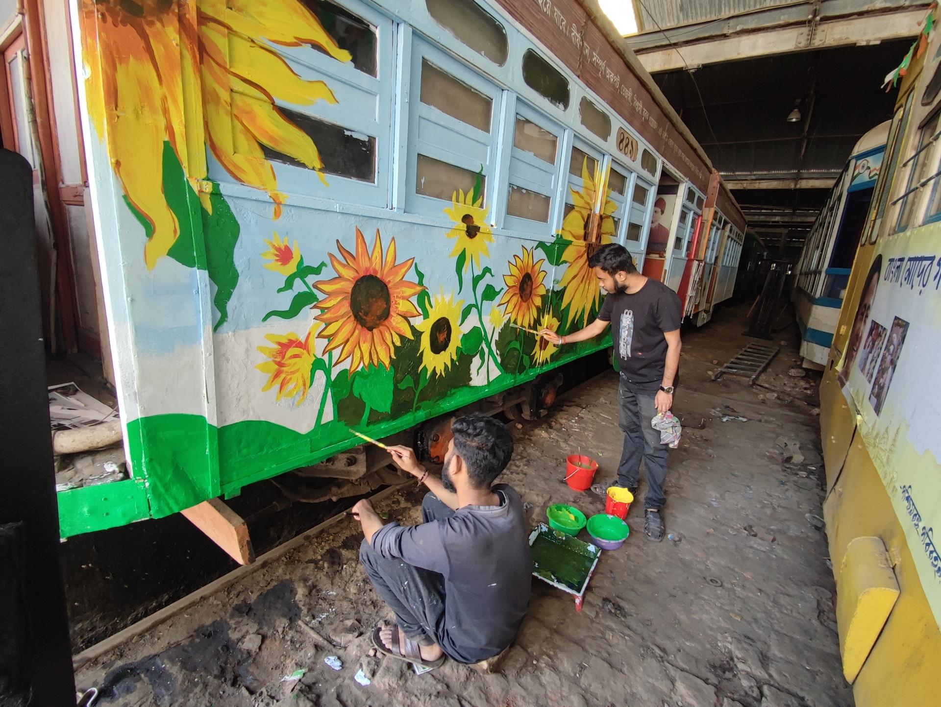 students painting a streetcar