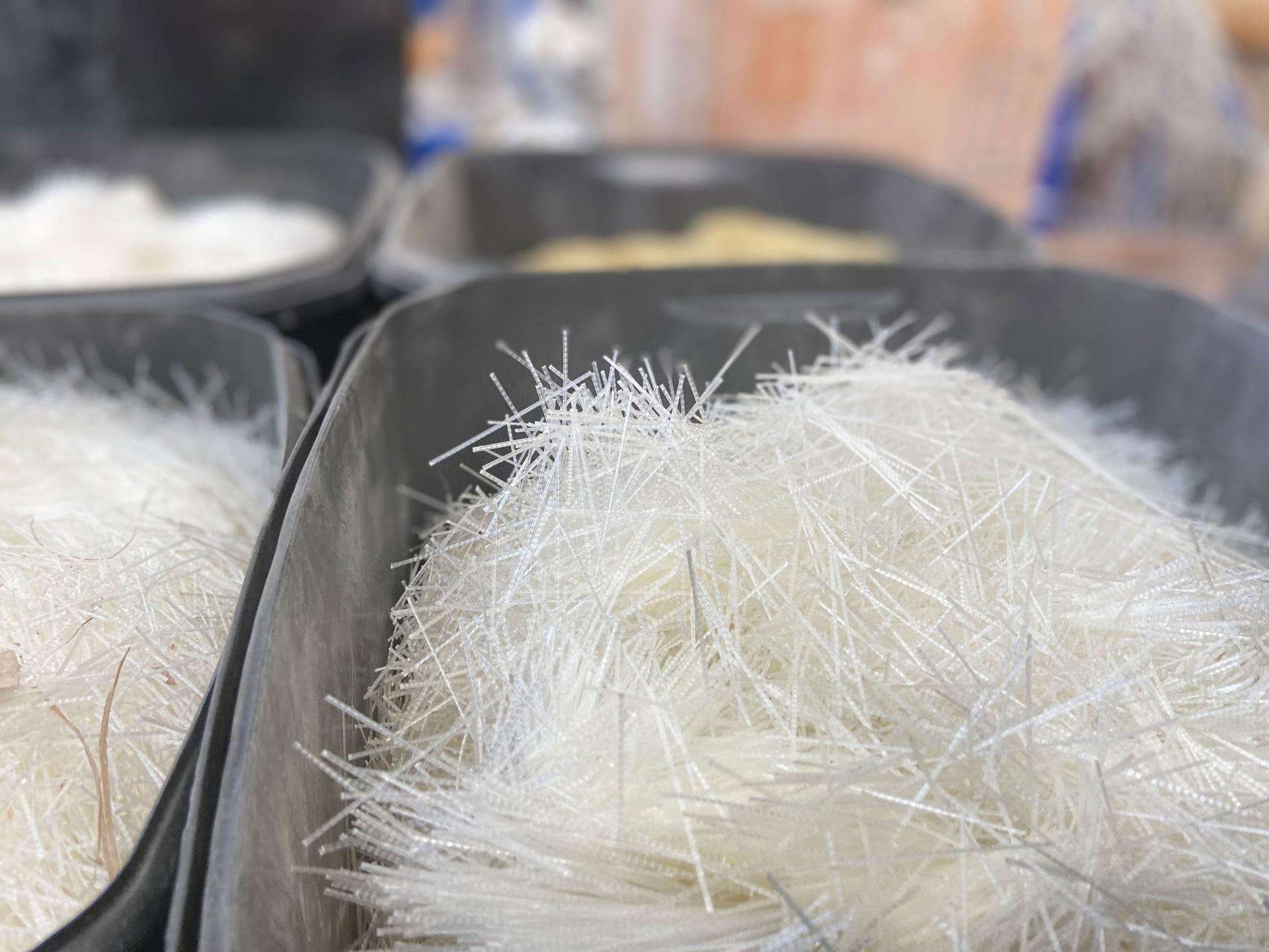 Buckets of microfibers sit at the ready inside the experimental lab. The fibers are mixed with concrete to give it incredible strength and resistance.   