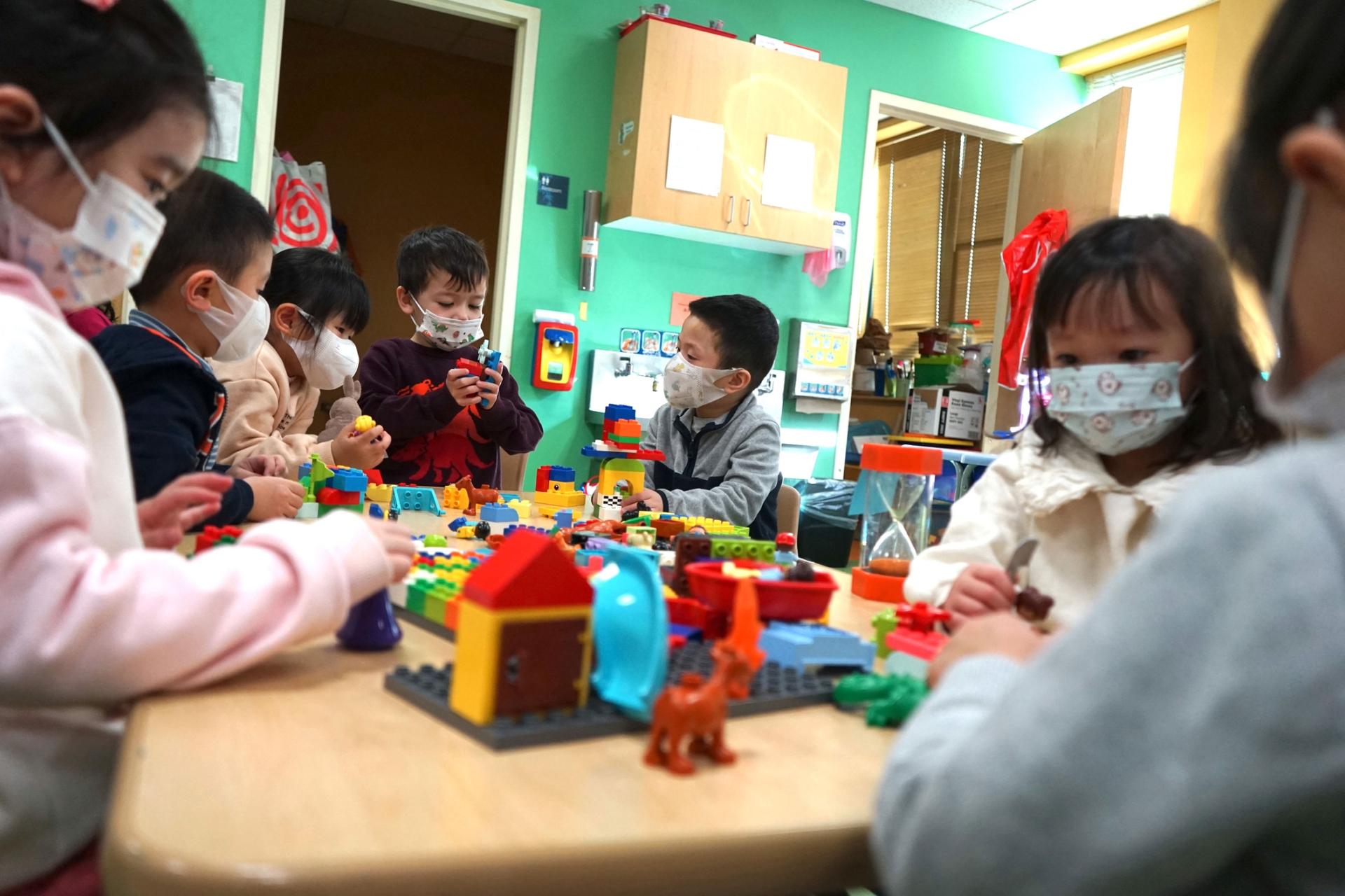 Children are abuzz with building Legos in the preschool classroom. 