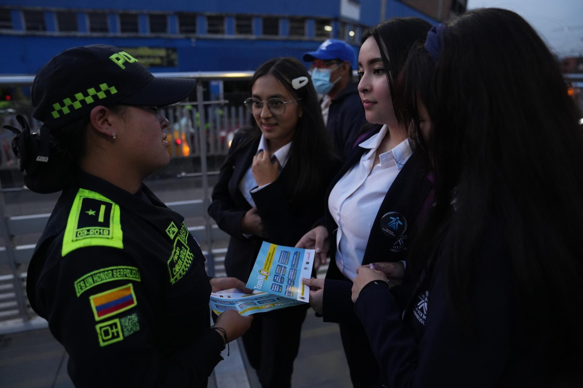 A police officer in Bogota, hands out leaflets that encourage women to report cases of sexual harassment in the city's public transport system.
