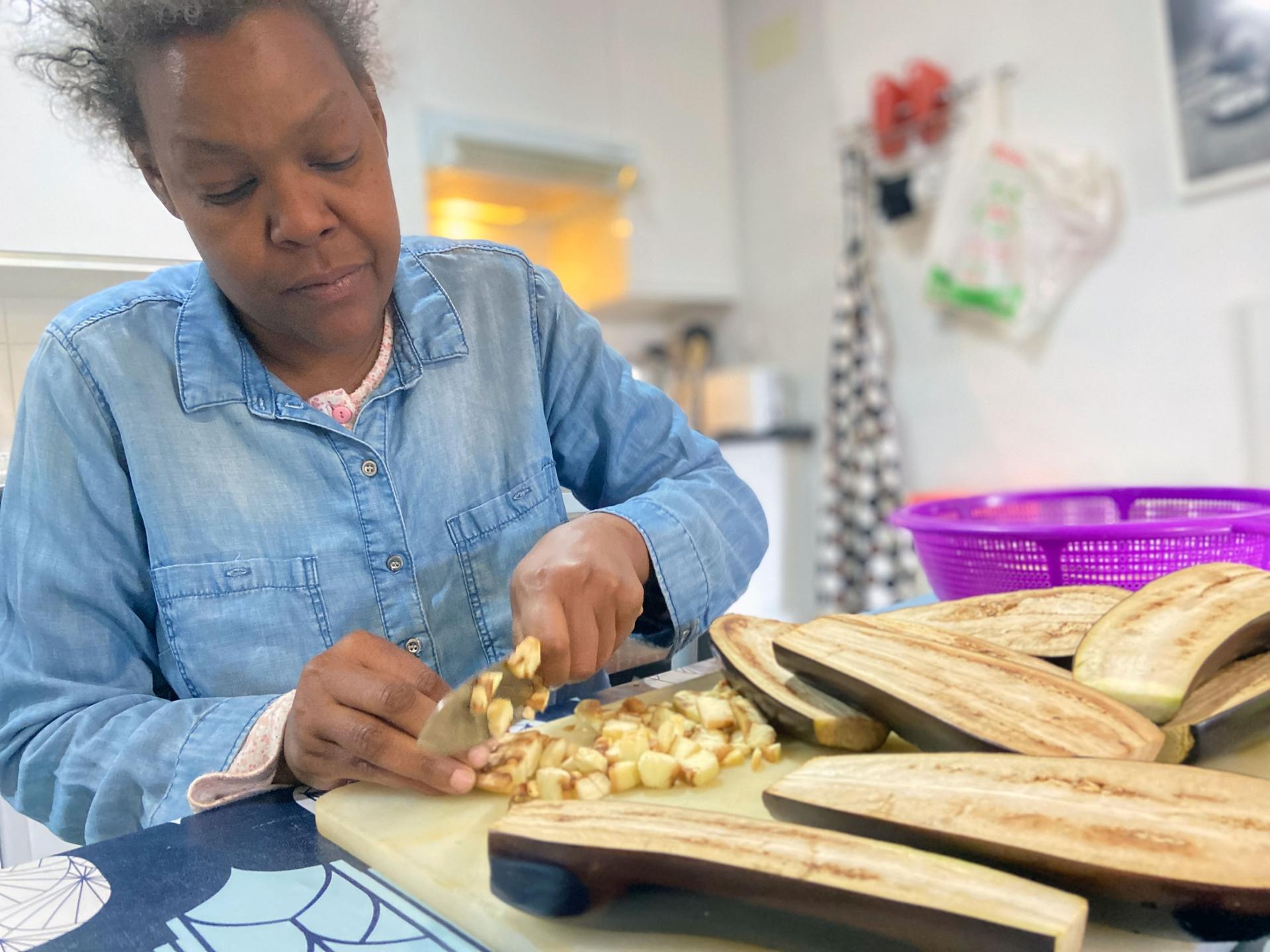 Vicky prepares vegetables for a meal for her and her nine housemates at Hogar Sí, a shelter for terminally ill homeless people in Madrid. Vicky is dying of cancer and was on the streets until recently. 