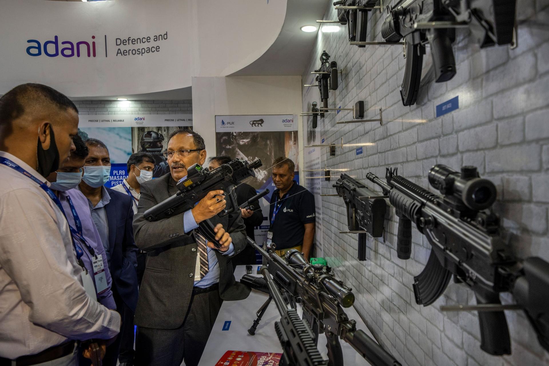 An exhibitor shows the working of an assault rifle manufactured by PLR Systems Private Limited, a Joint Venture between Adani Group, India and Israel Weapon Industries (IWI), Israel, at the International Police Expo 2022 in New Delhi, India, Wednesday, Ju