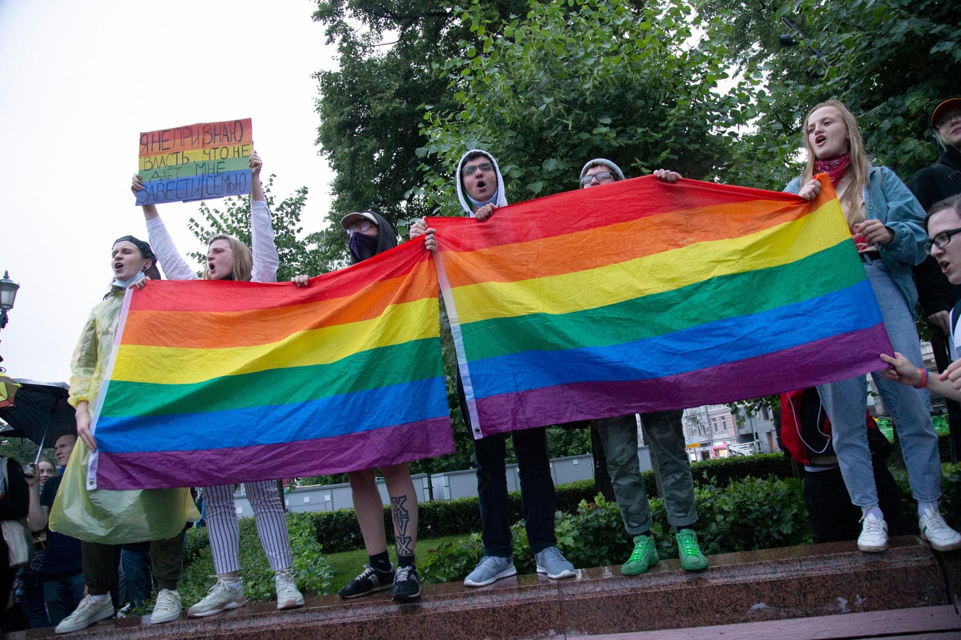 LGBTQ activists wave rainbow-colored flags during a rally in Moscow, Russia, Wednesday, July 15, 2020.