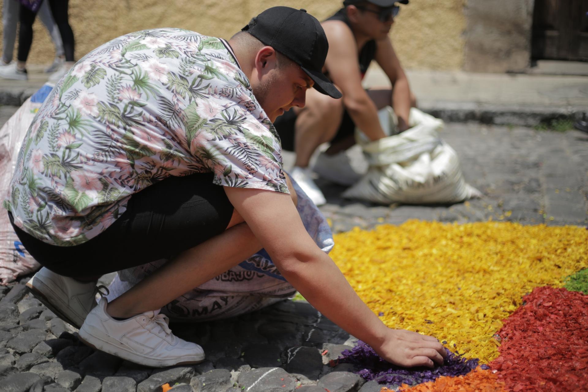 Francisco Orellana works on an alfombra, or street carpet, with his friends for Holy Week, Antigua, Guatemala,
