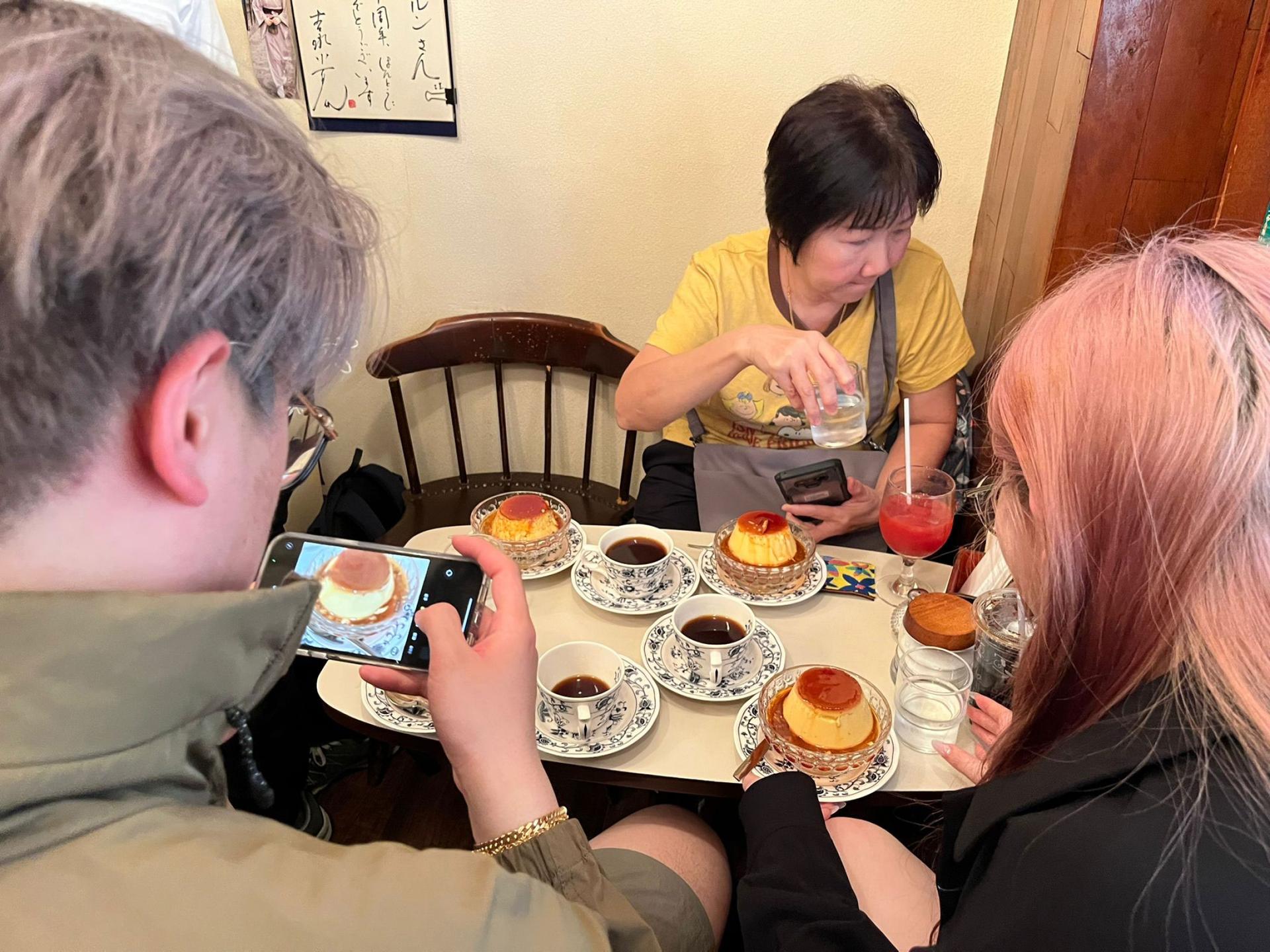 Customers snap photos of the famous pudding before digging in to the treat. 