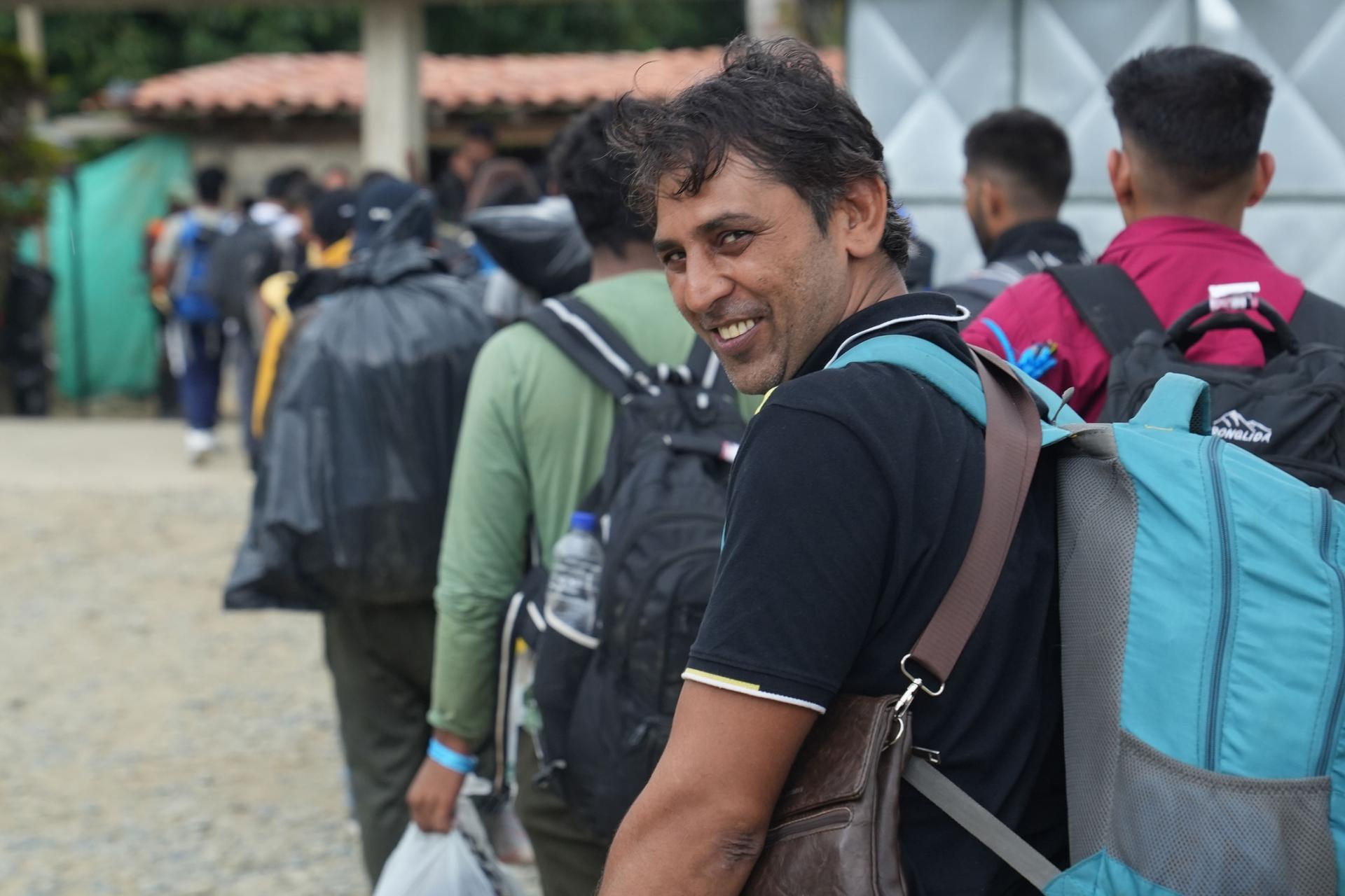 Migrants who pay for guides are quickly led out of the shelter, and start the trek across the rainforest. 