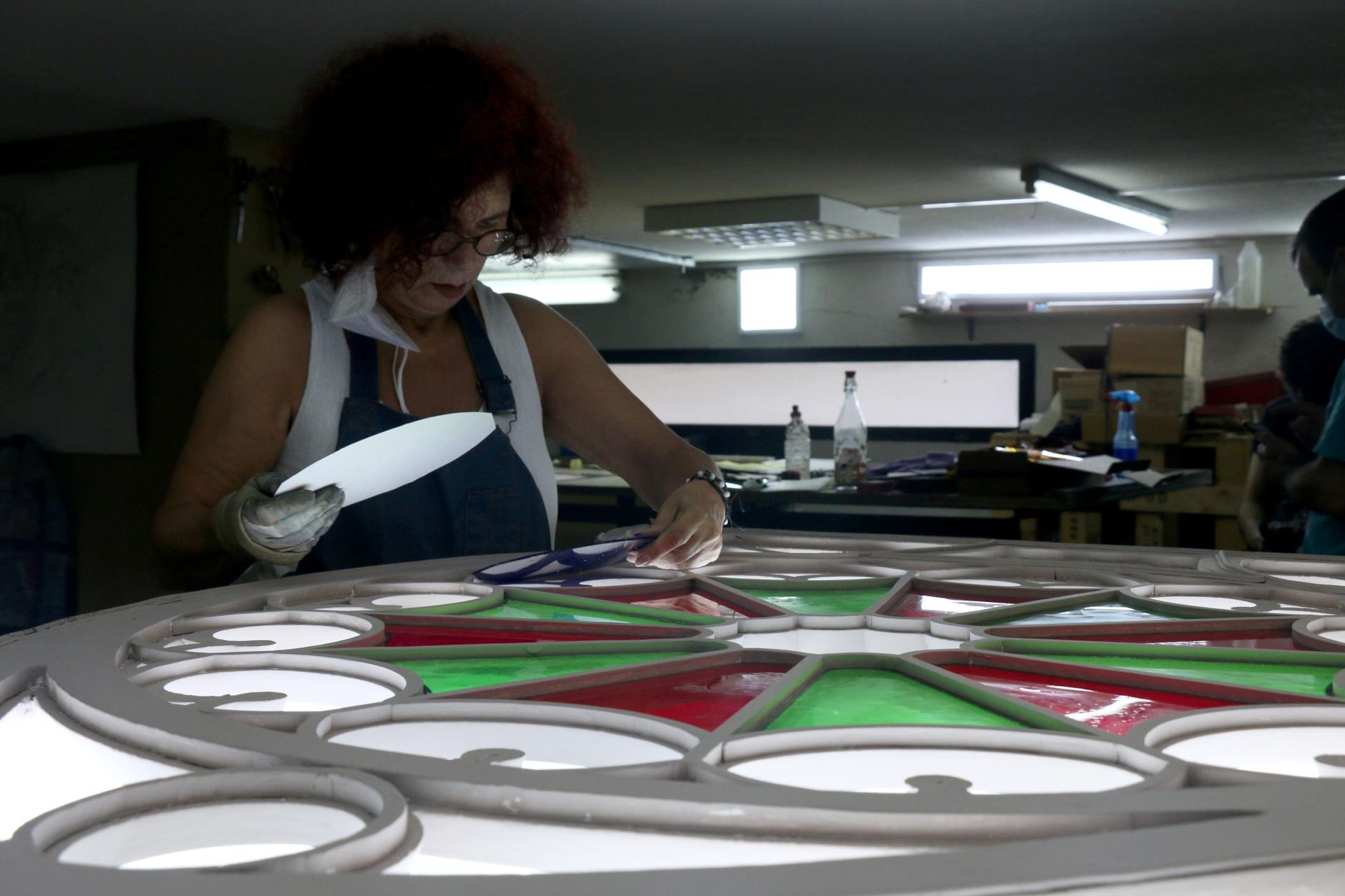 woman works on stained glass