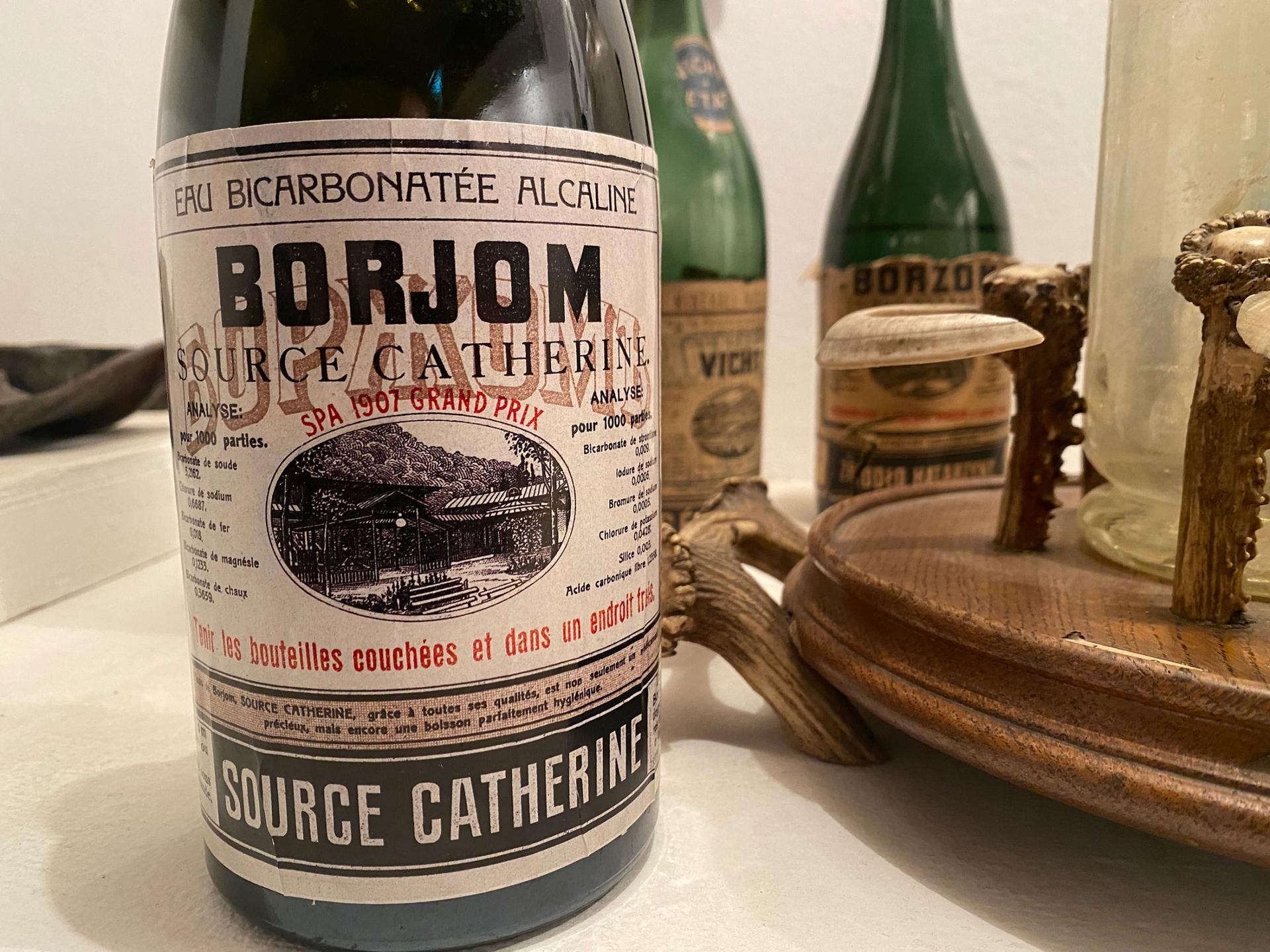 Old bottles of Borjomi that show the product's previous labels over the decades stand in the town's museum.