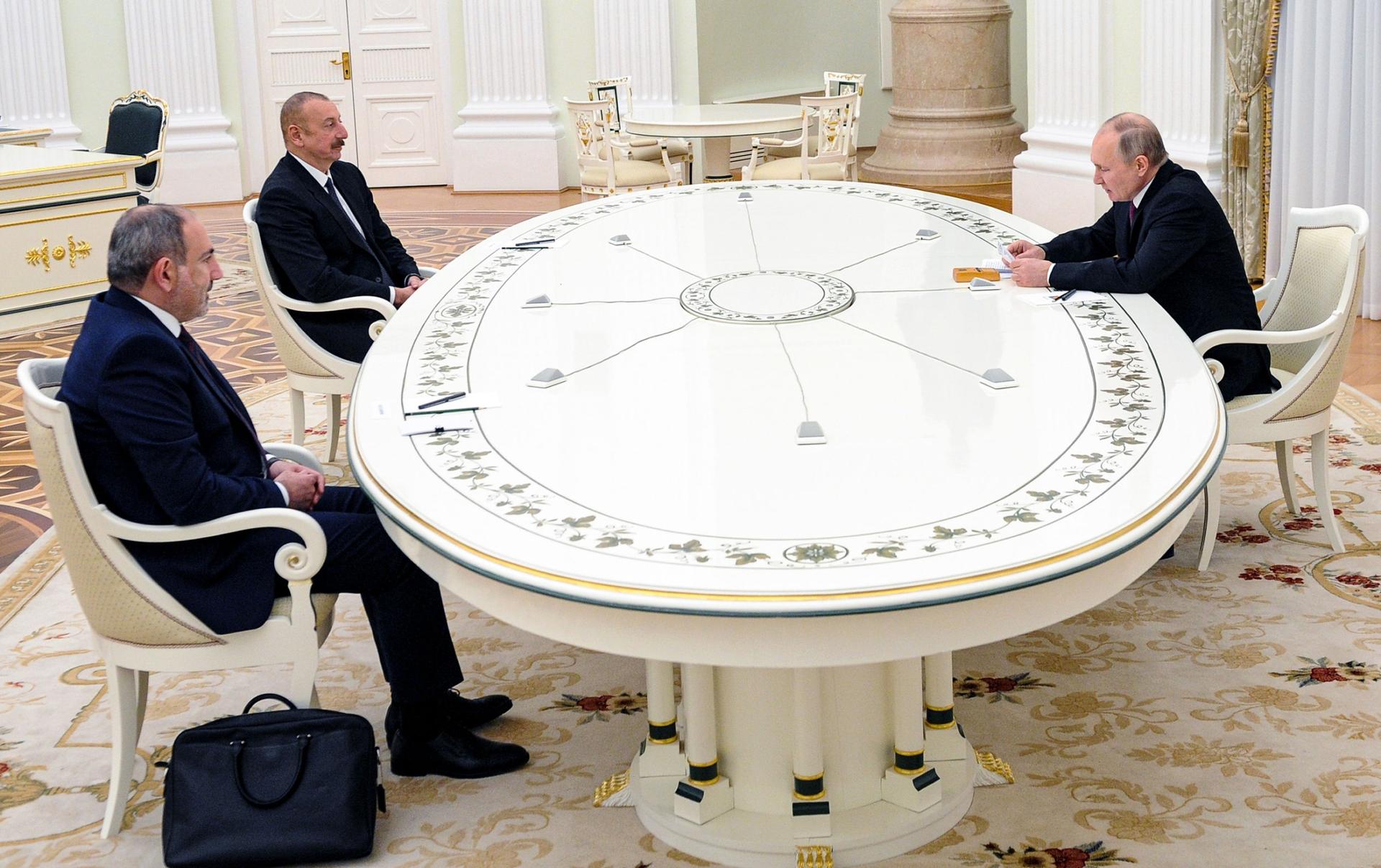 Russian President Vladimir Putin, right, attends talks with Azerbaijan's President Ilham Aliyev, second left, and Armenian Prime Minister Nikol Pashinyan, left, at the Kremlin in Moscow, on Jan. 11, 2021. 