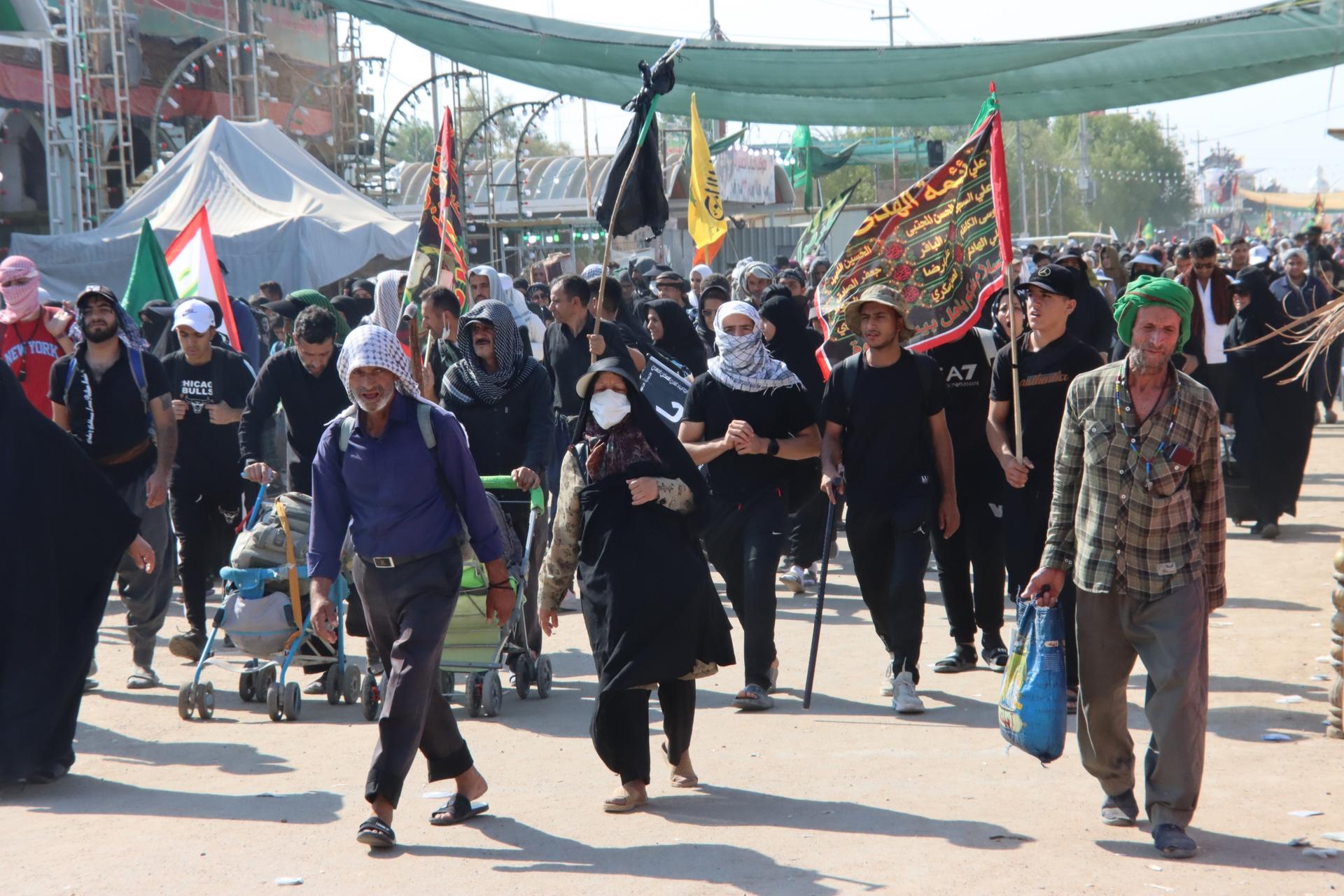 People on the Arbaeen walk on the road between the Iraqi cities of Najaf and Karbala, September 2023.