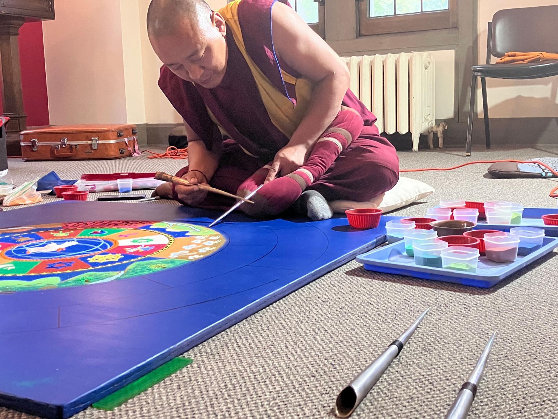 The monks work solo and in groups to complete various aspects of the intricate design for world peace.