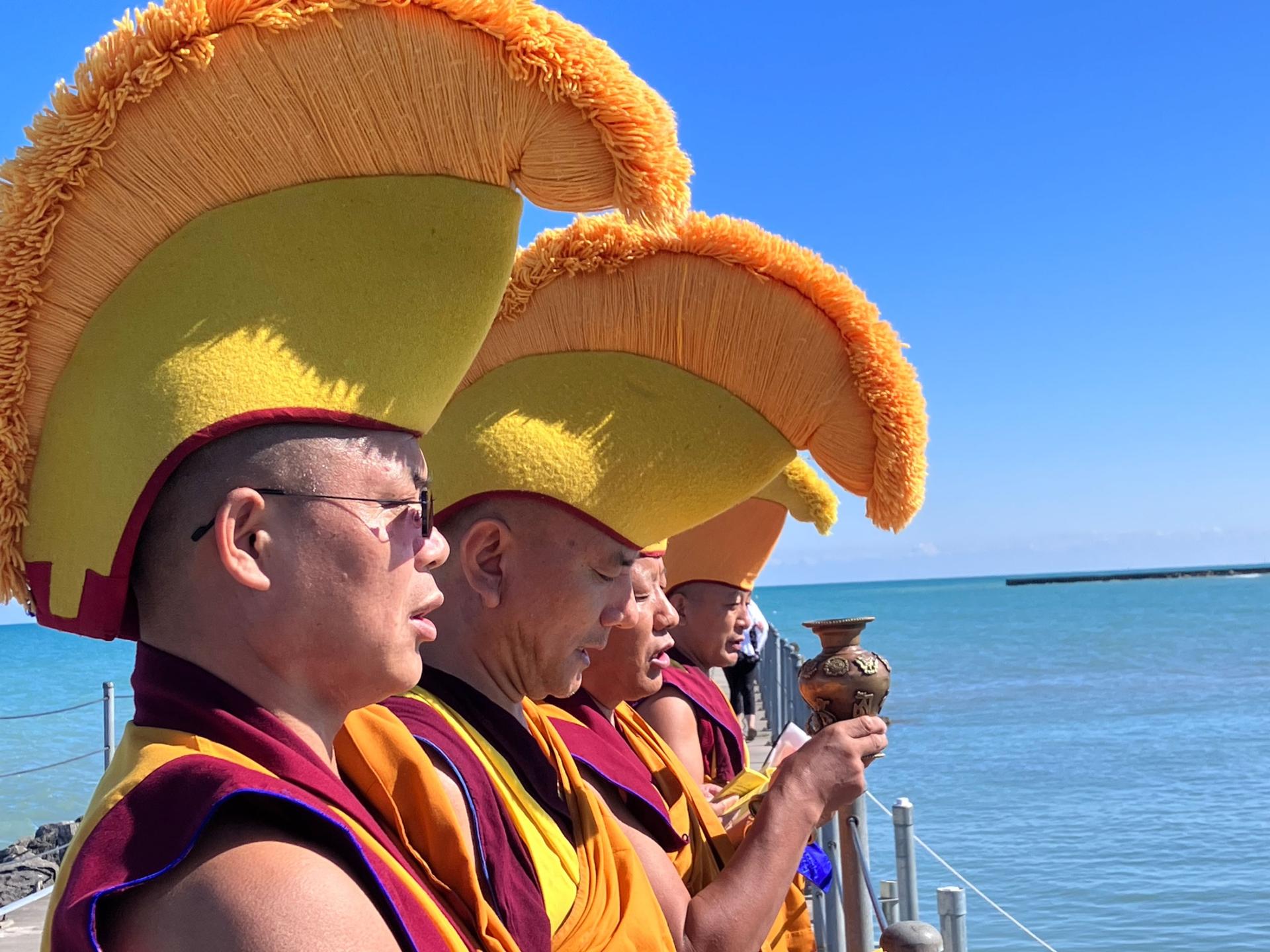 The monks release the remains of the sand mandala into the lake, with a prayer that their blessings may flow out into the world.