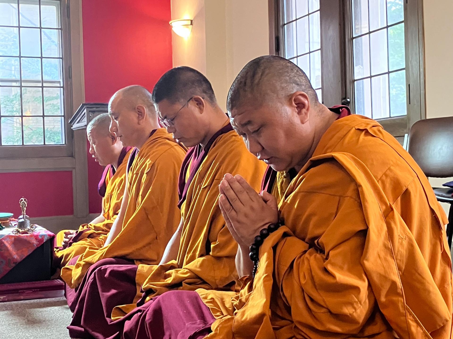 The traveling monks open each day with chanting and prayers facing the mandala-in-progress.