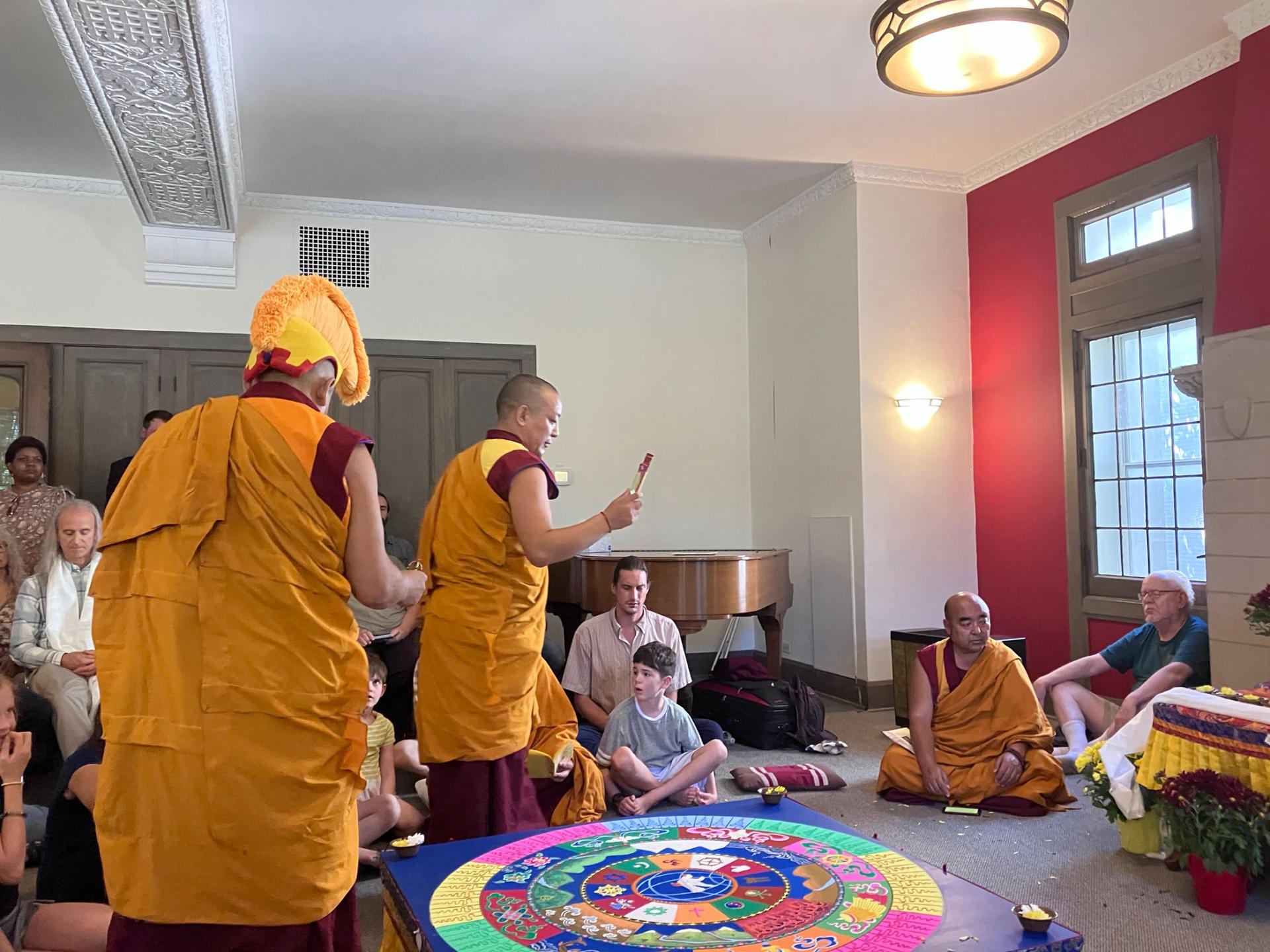 The monks encircle the elevated mandala to say prayers before its destruction, Sept. 9, 2023, Evanston, Illinois.