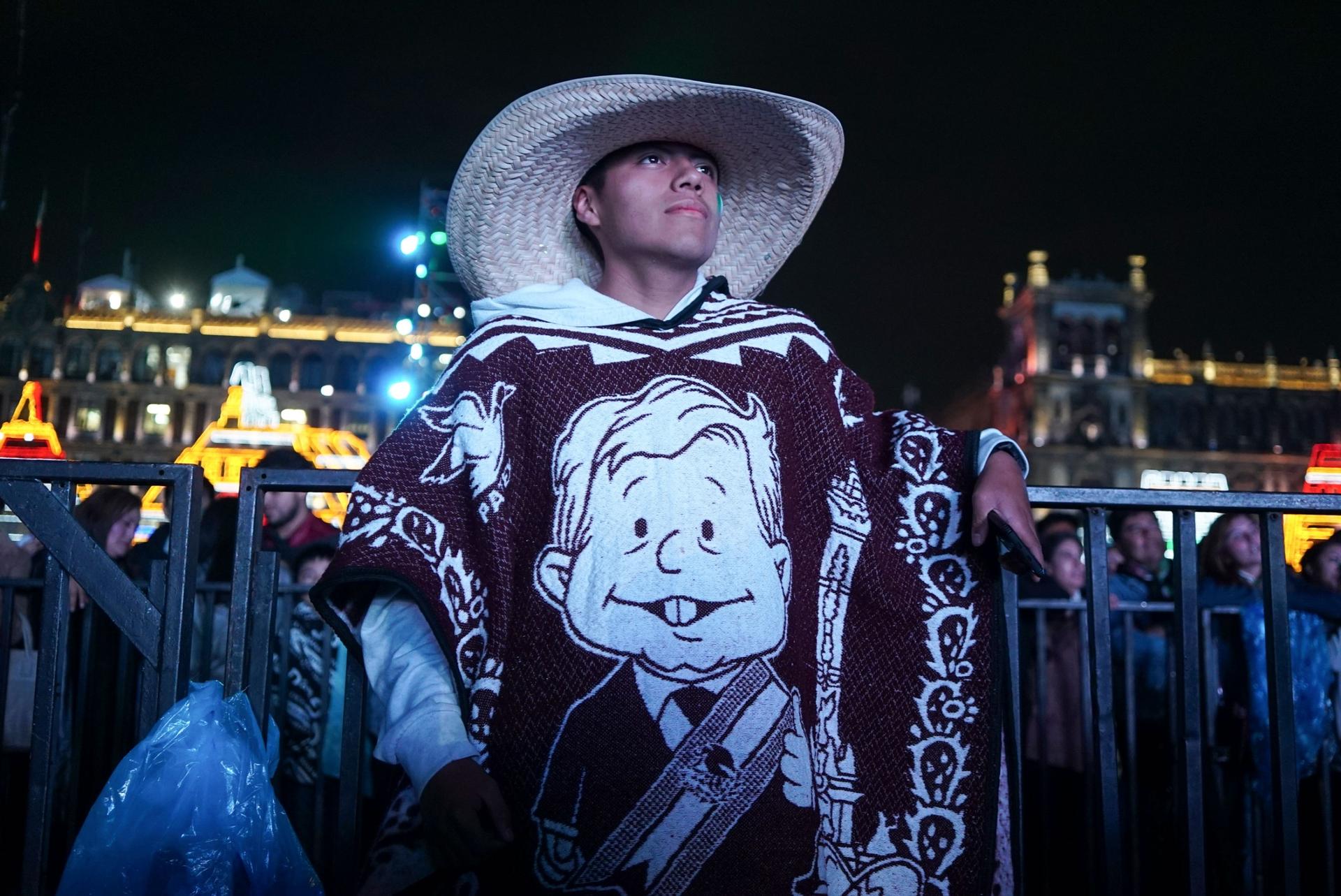 A young man watches a performance during a celebration of Mexican Independence Day.