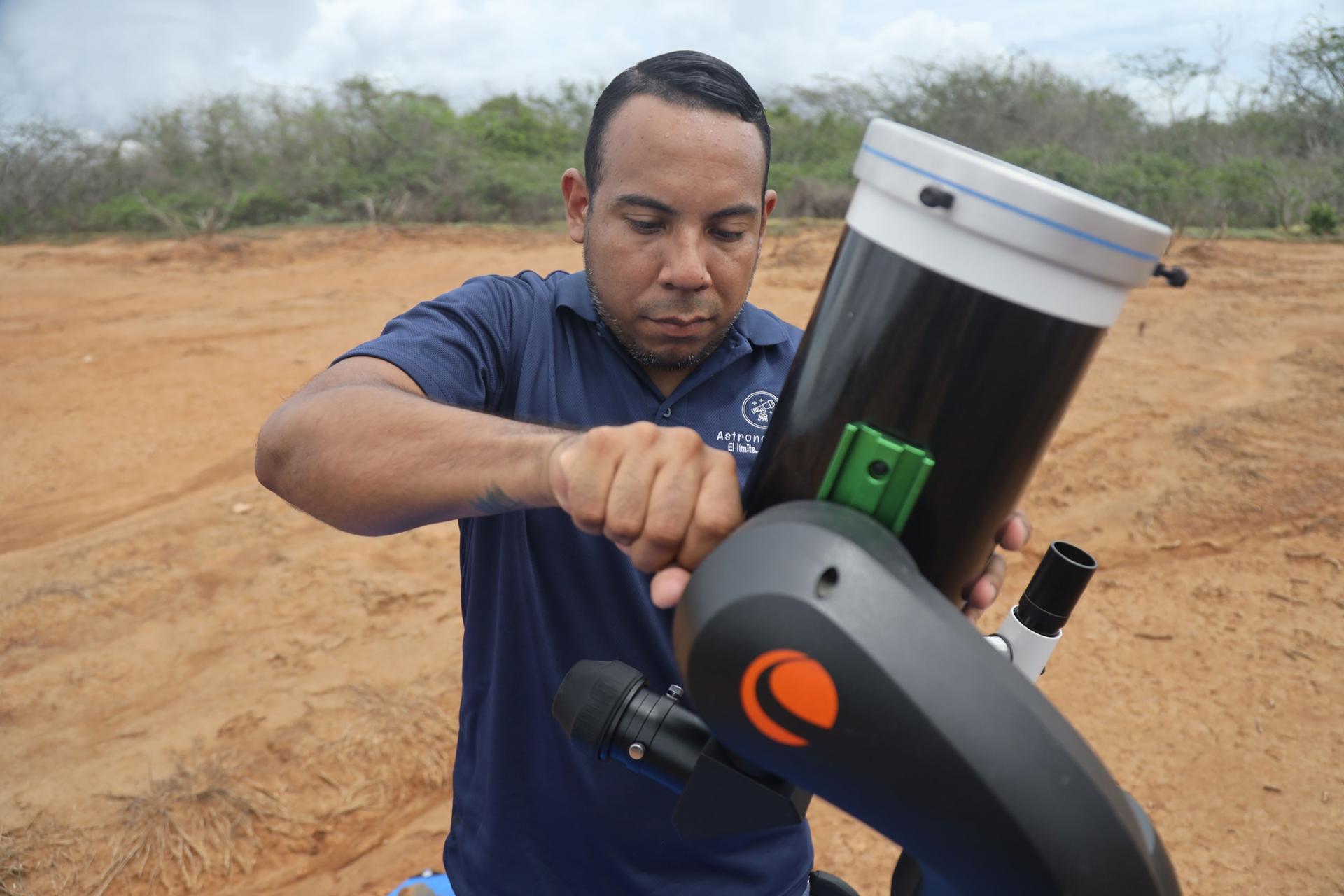 Gregory Guerrero adjusts the telescope.