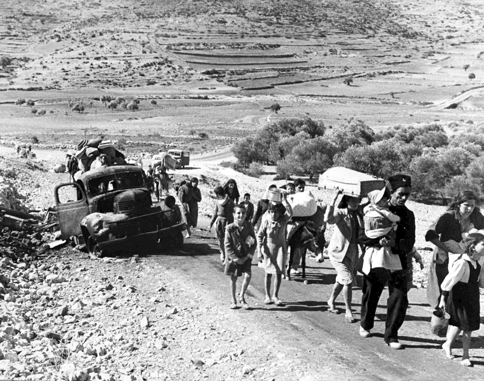 A group of Arab refugees walks along a road from Jerusalem to Lebanon, carrying their belongings with them, Nov. 9, 1948.