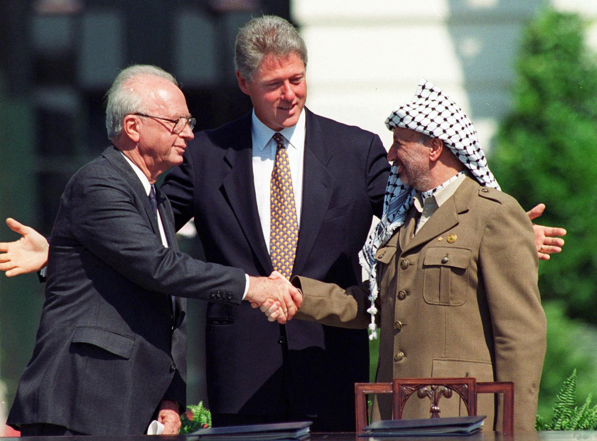 Israeli Prime Minister Yitzhak Rabin, left, and Palestinian leader Yasser Arafat shake hands marking the signing of the peace accord between Israel and the Palestinians, in Washington, Sept. 13, 1993.