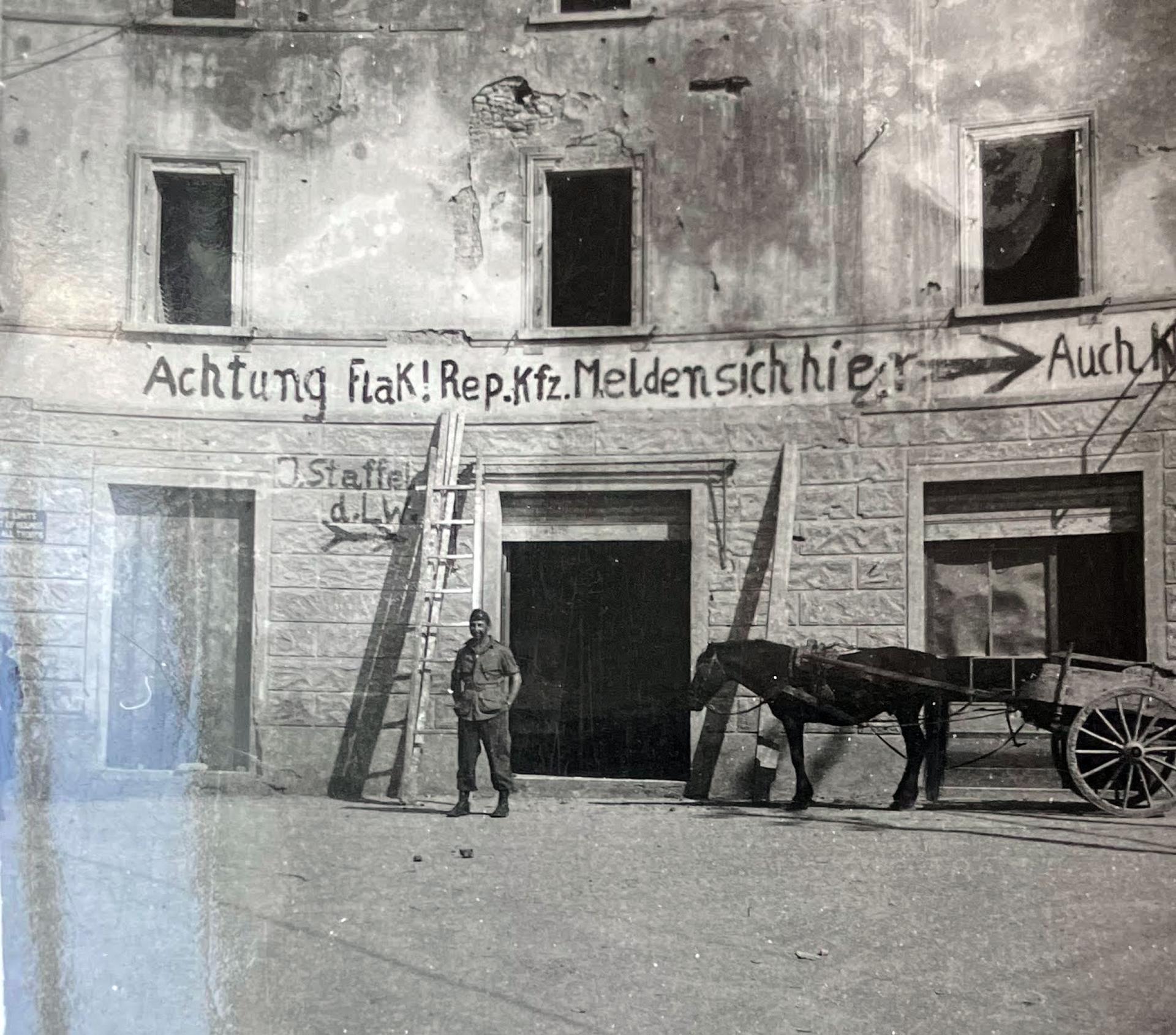A photo depicts German writing on the walls warning of ammunitions, southern Italy, 1945. 