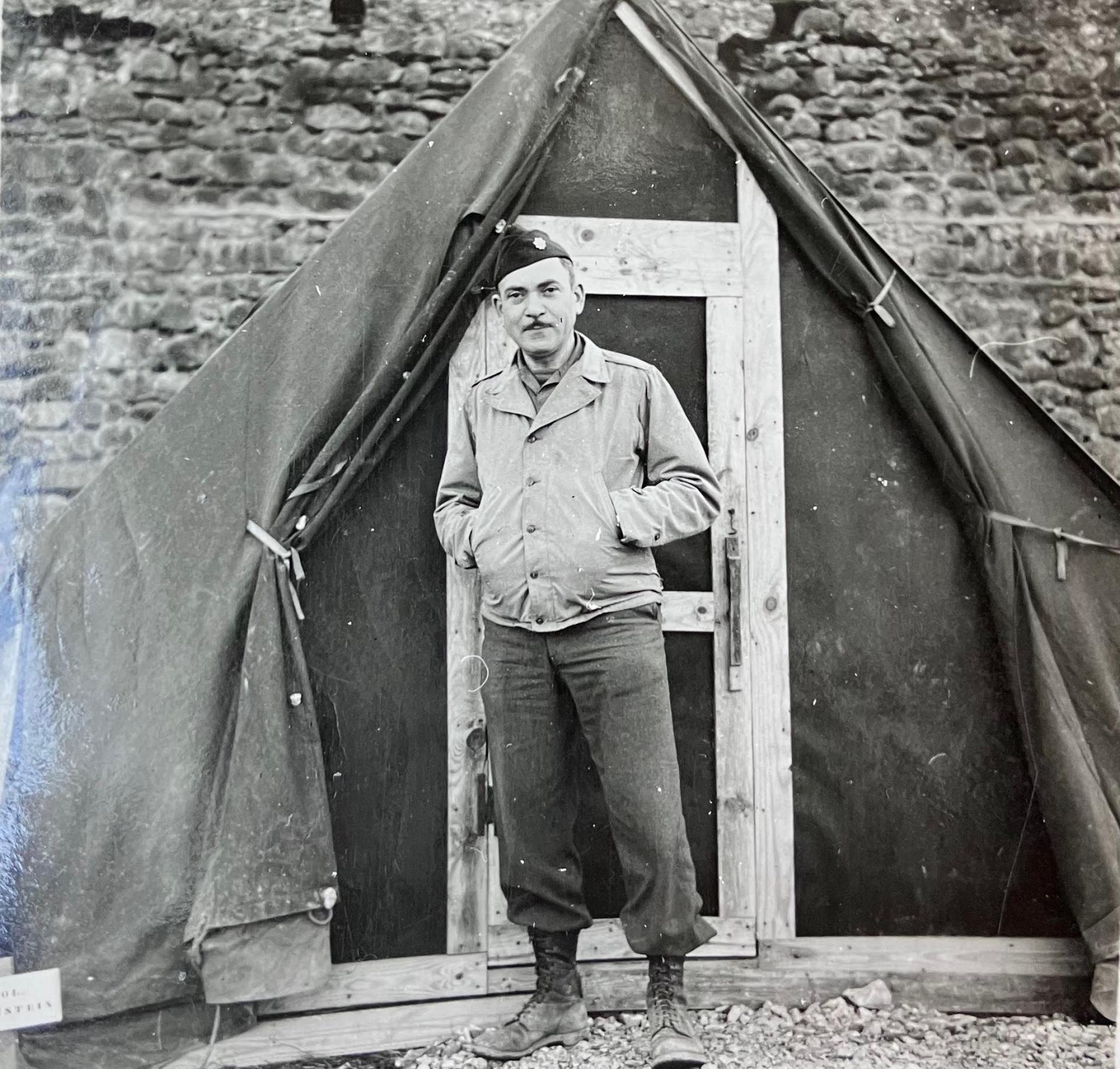 Lt. Col. Manuel E. Lichtenstein, chief surgeon with the 16th Evacuation Unit, Michael Reese Hospital, stands in front of a tent in southern Italy, 1944.