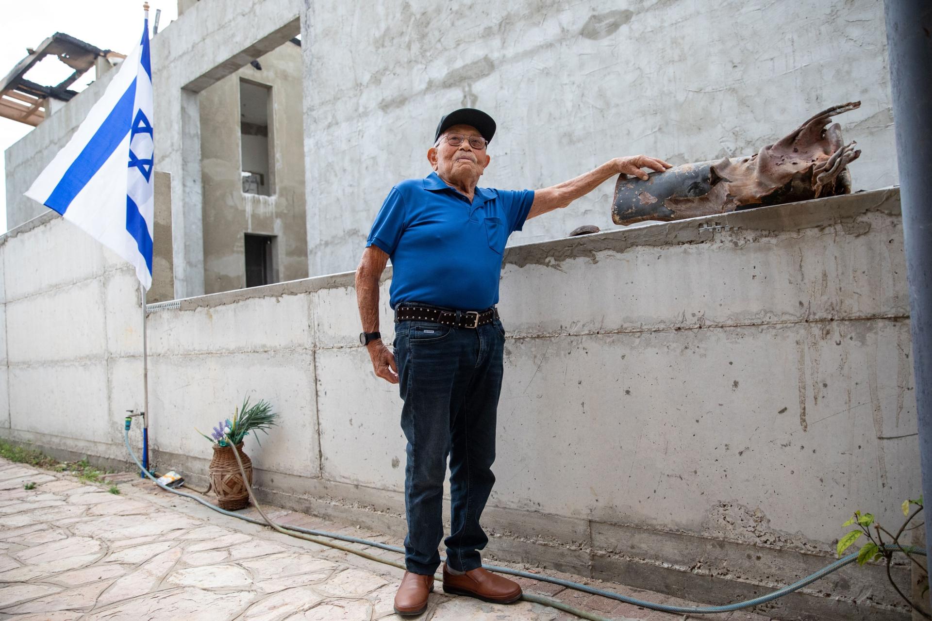 Isaiah Foyer, 90, stands in front of his house in Ashkelon. 