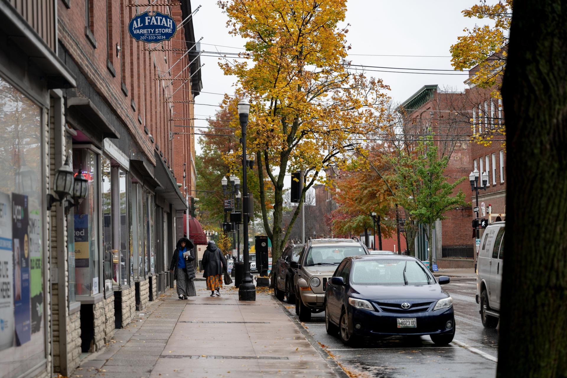 People walk through downtown Lewiston, Maine on Oct. 30, 2023. Somali business owners have been credited with reviving the once-moribund downtown of this former mill city. 