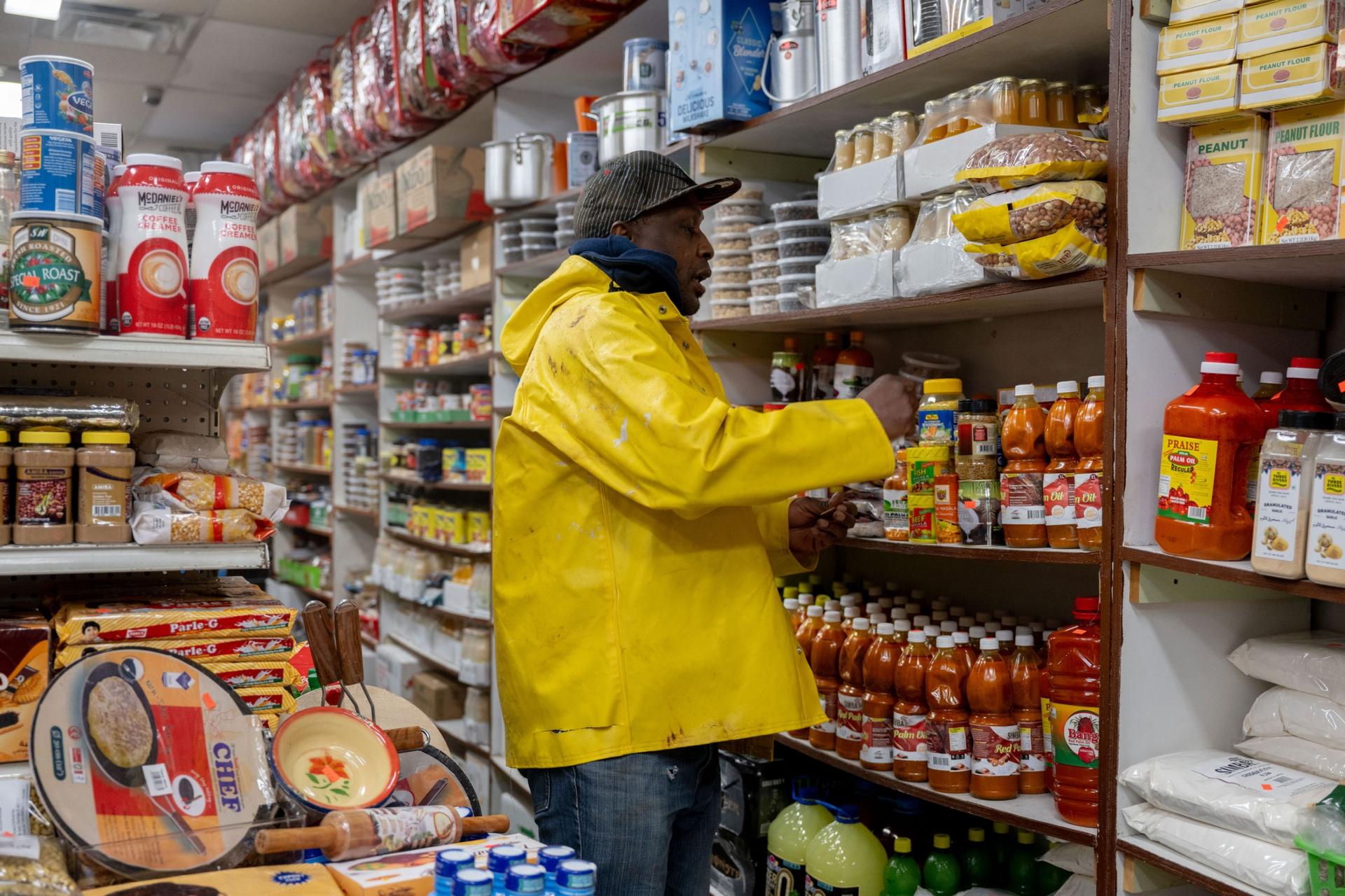 Lewiston resident Claude Imeka looks around Mogadishu Store before purchasing items in Lewiston, Maine, on Monday, Oct. 30, 2023. 