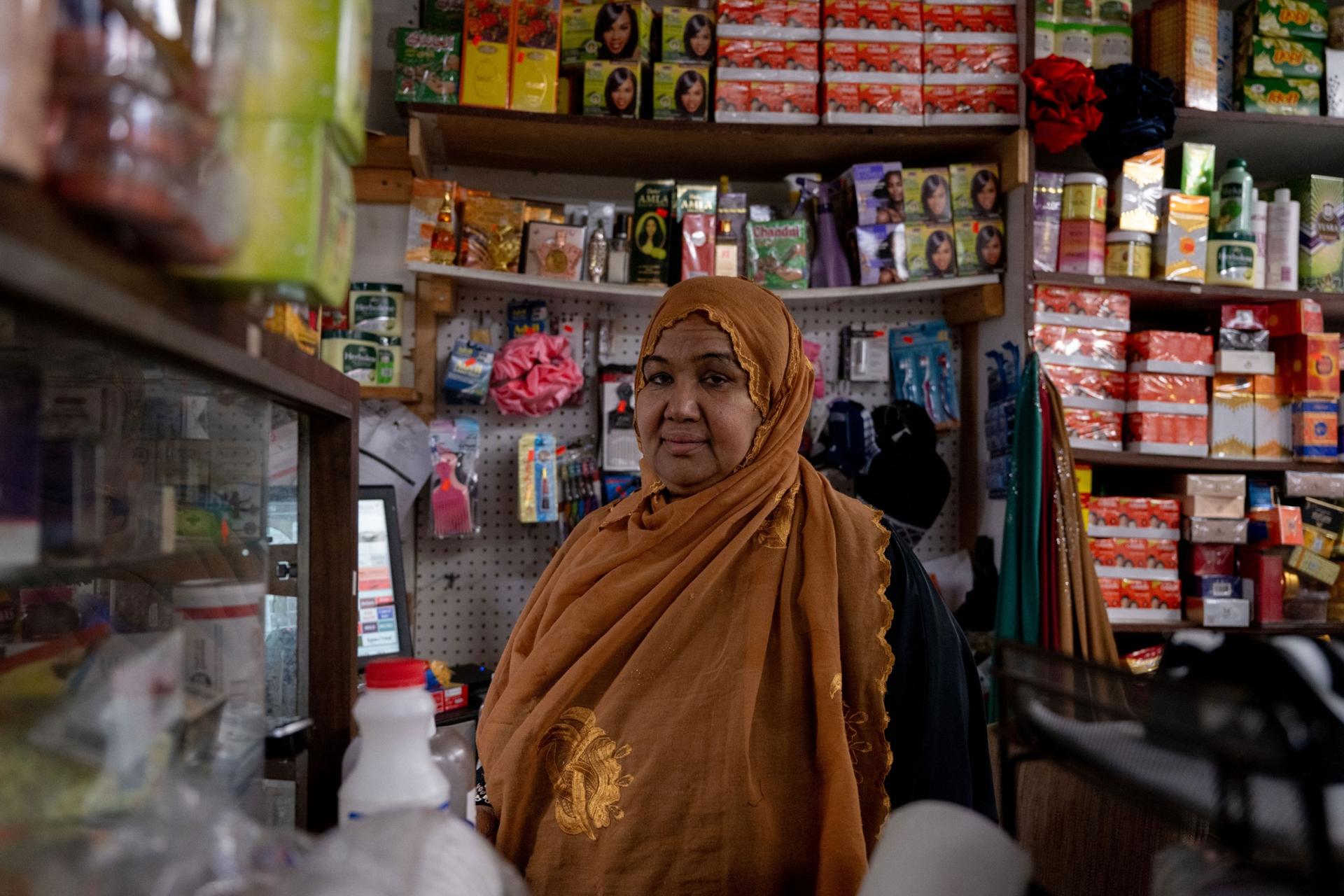 Shukri Abasheikh, owner of Mogadishu Store, poses for a portrait in her store in Lewiston, Maine, on Monday, Oct. 30, 2023. 