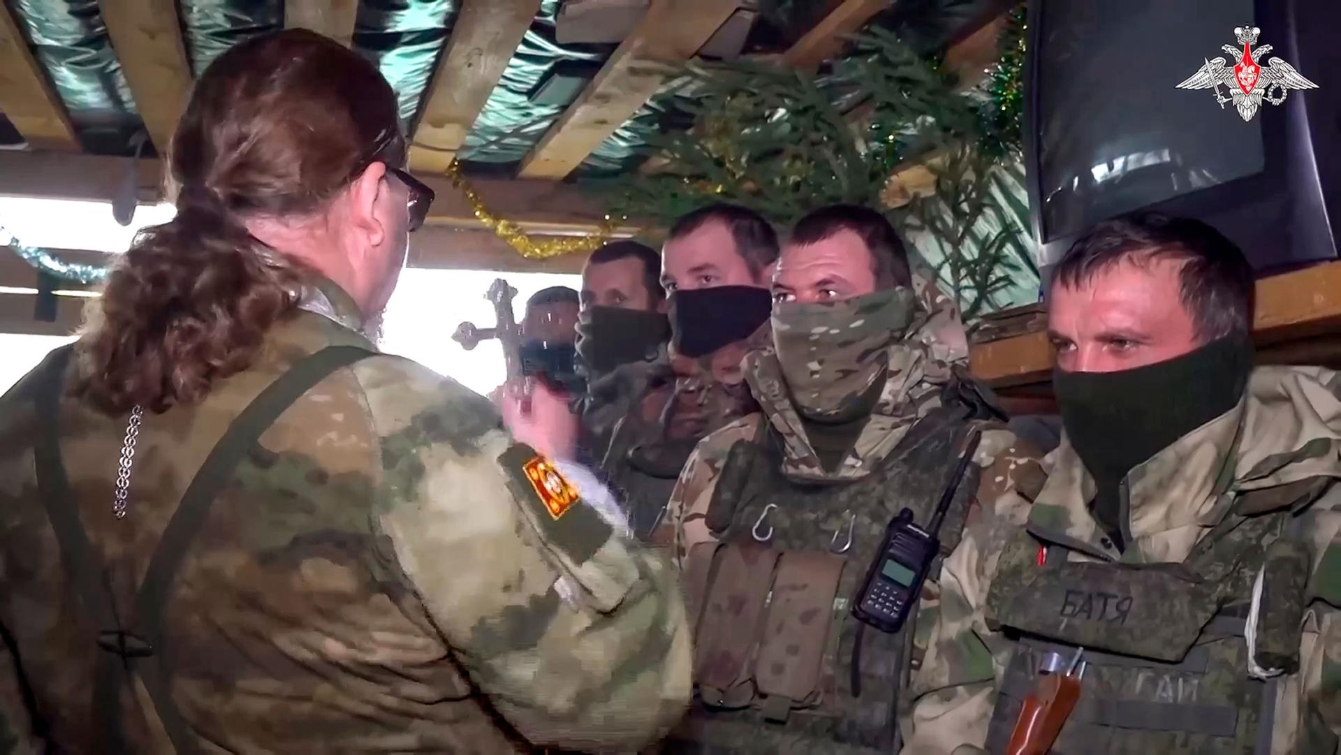 In this photo taken from a video released by the Russian Defense Ministry Press Service on Sunday, Jan. 7, 2024, a Russian Orthodox Church priest conducts an Orthodox Christmas service for servicemen on a mission during a special military operation in Ukr