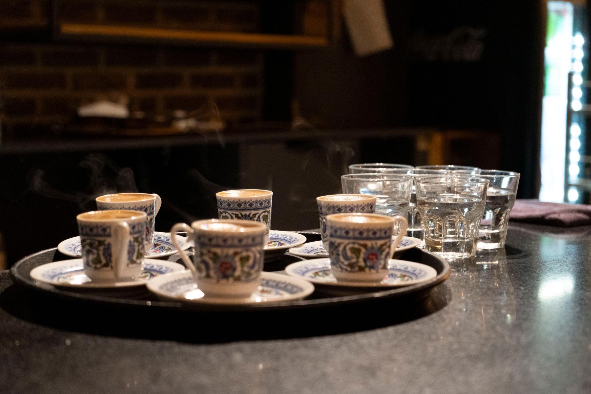 Steam emerges from small, delicate cups of bold Turkish coffee.