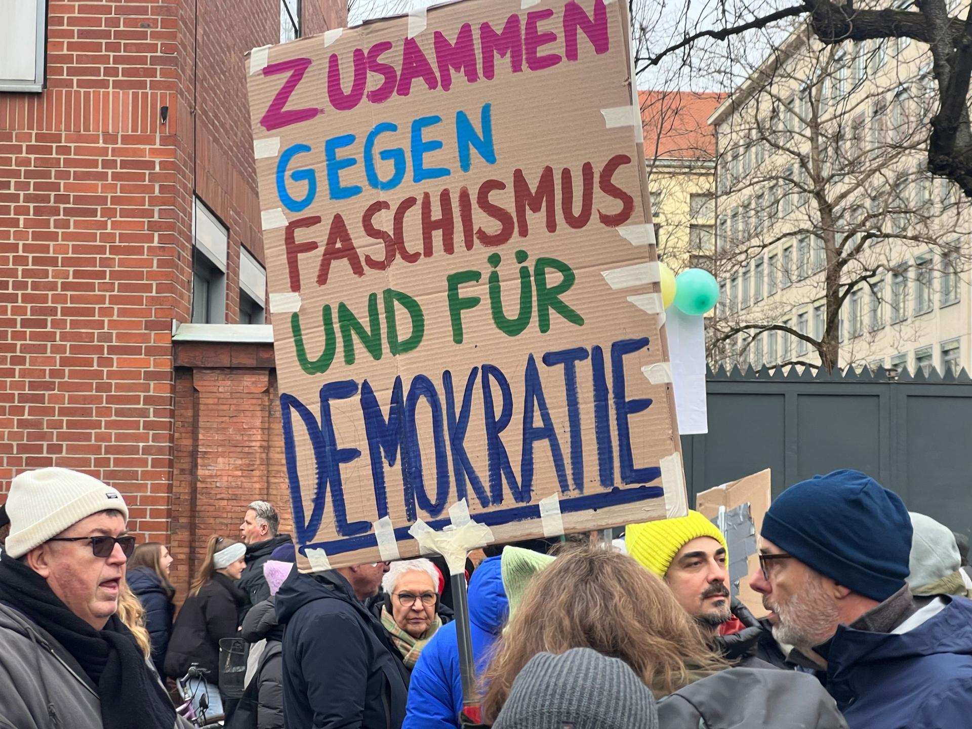 A sign held by a protester reads, "Together against fascism and for democracy." On Jan. 21, 2024, in Munich, tens of thousands of protesters packed grand Ludwigstraße to protest growing far-right influence in the country.
