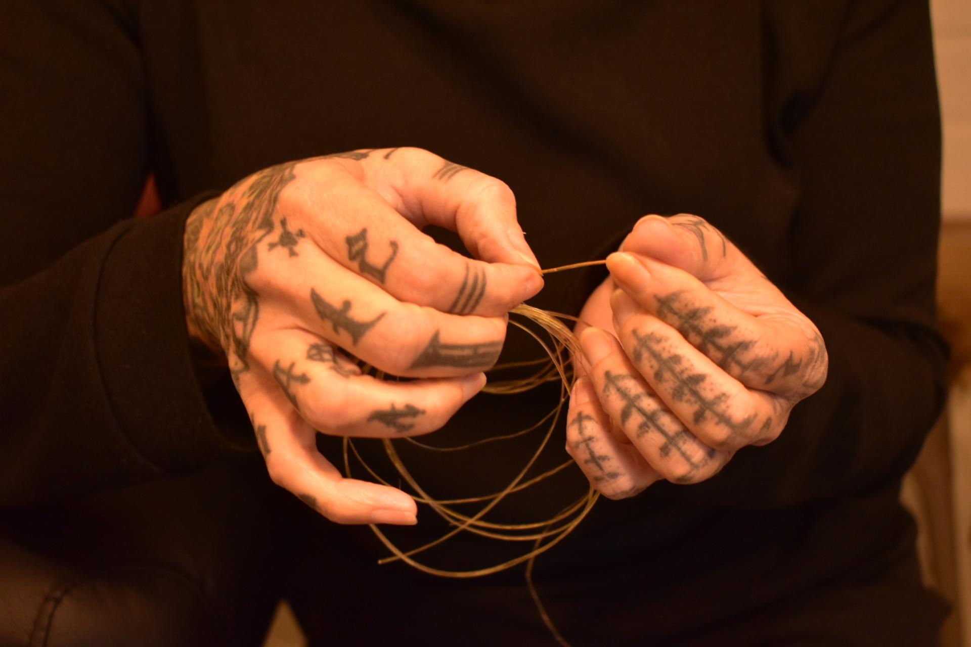 In her tattoo studio in Svendborg, Denmark, artist Maya Sialuk Jacobsen unravels handmade thread made of animal sinew, Dec. 9, 2022.