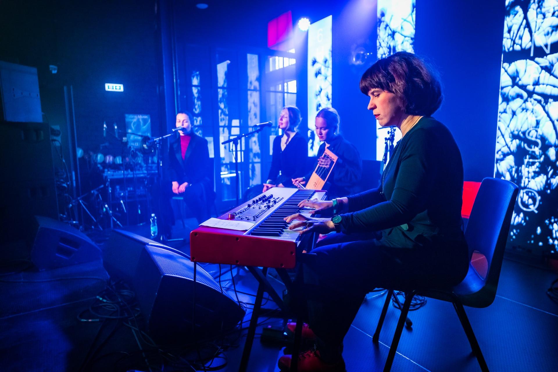 On the far right, Kaisa Kuslapuu plays the keyboard on the "Folktronica" stage during Tallinn Music Week.