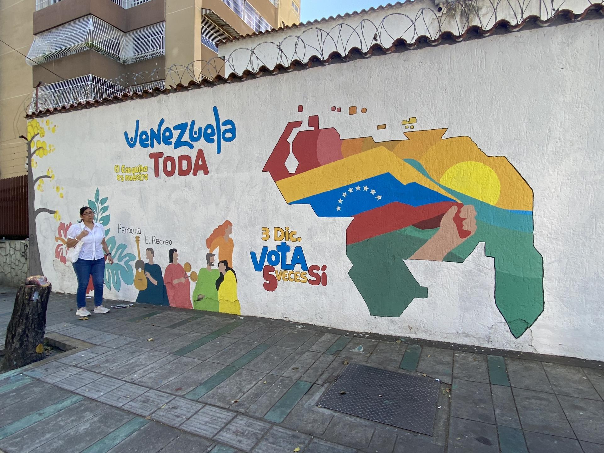 A colorful mural in Caracas depicts a map of Venezuela that includes the disputed Essequibo region. It's the long strip of land to the right of the rising sun. 