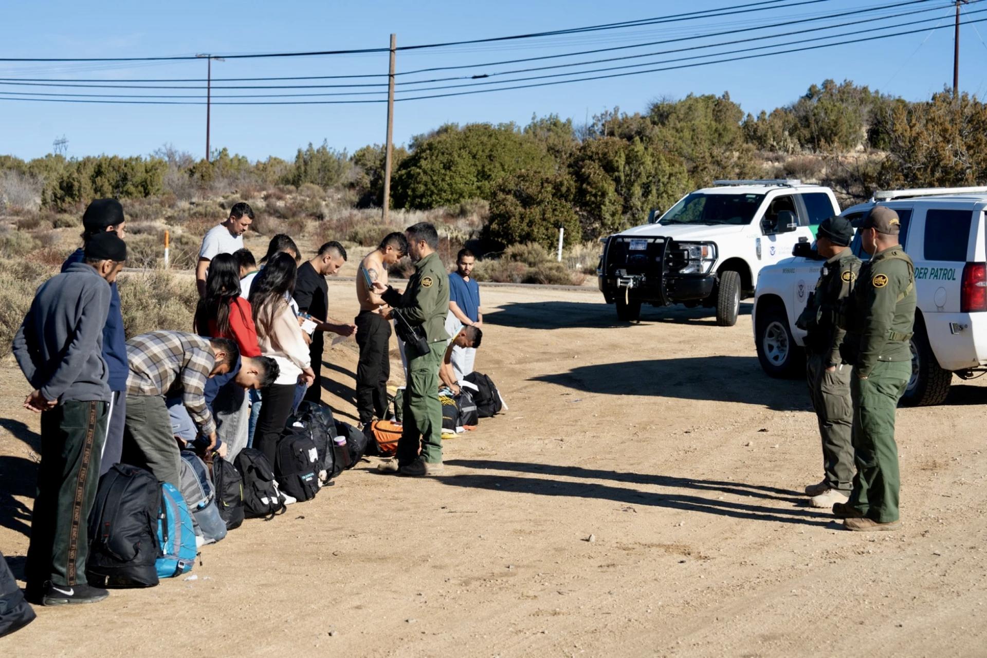 Migrants are told to strip down to one layer before boarding the transport bus near Old Highway 80 on Jan. 4, 2024