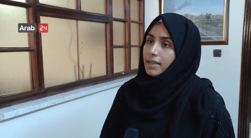 Woman wearing black hijab speaks to media 
