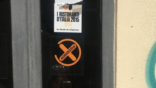 A restaurant displays the Addiopizzo sign on its doors to show it doesn't support the Mafia.