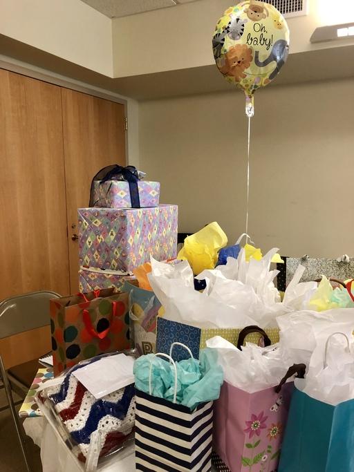 Balloons and gifts on the table at a baby shower