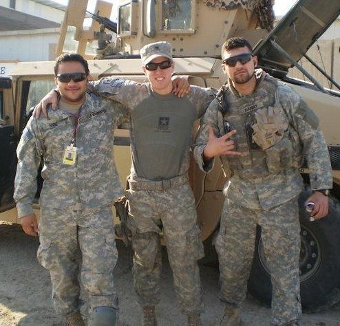 Three men in military uniforms arm in arm 