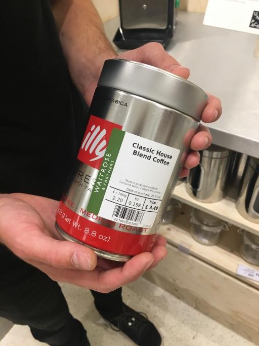 A Waitrose customer shows off the container he brought to fill with coffee.