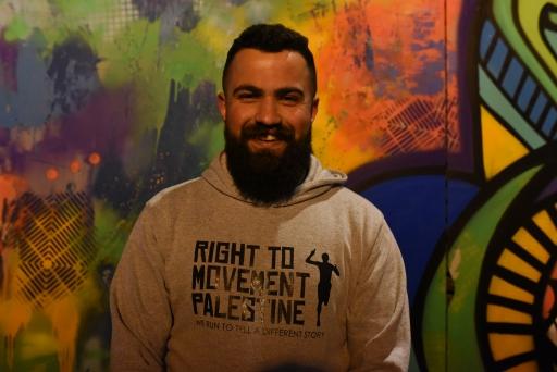 A portrait of Mahmoud Lafi, leader of Right to Movement, wears a grey sweatshirt 
