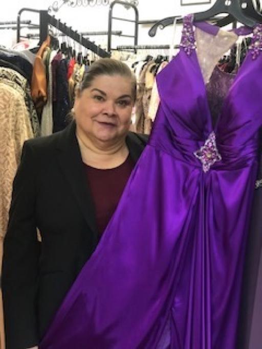 Ida Ann Pedregó poses with a dress at her boutique in Douglas, Arizona. She closed the store indefinitely March 21 due to the coronavirus outbreak.