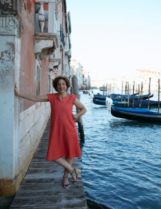 Jane Da Mosto, seen on the edge of a Venetian canal, is not complaining about the lower number of tourists visiting her hometown these days. 