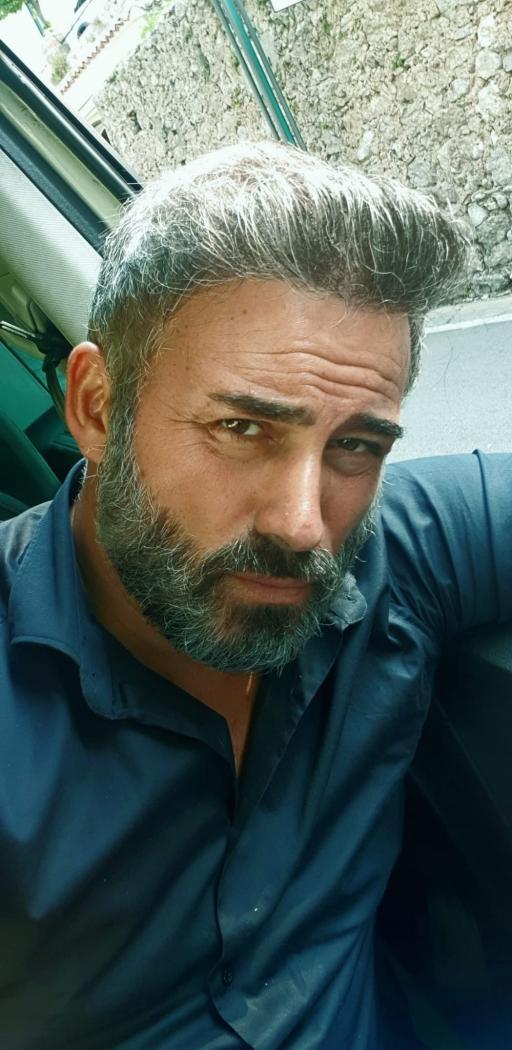 Naples taxi driver Ciro la Motta, with salt-and-pepper beard. 