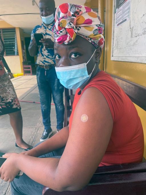 Gloria Yeboah, 18, receives her COVID-19 jab. 