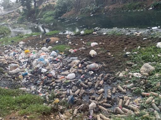 Open drains are engulfed by plastic waste in central Ghana. 