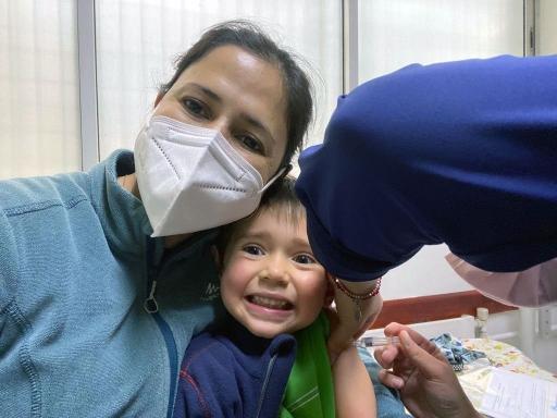 Shirley Monsalve González and her son, Pedro, smile while he gets his COVID-19 shot. 