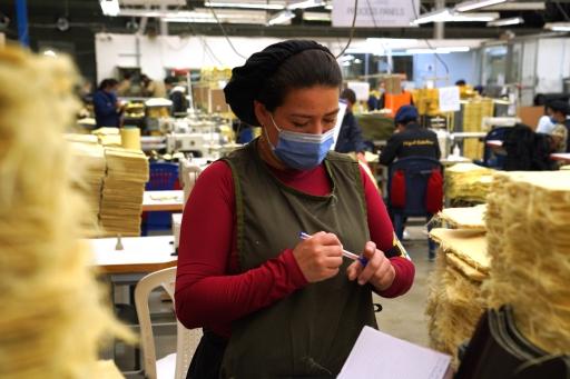 A woman works at the MC Armor plant in Bogota, Colombia, that's producing bulletproof vests and other gear for people in Ukraine.