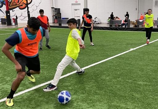 Newly arrived Afghan refugees play soccer at a St. Louis sports facility. For many, it's a chance to do something familiar during a time of profound change.