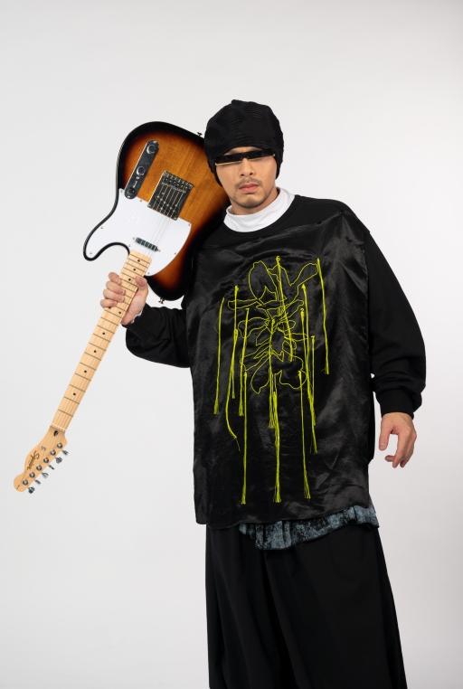 Malaysian Chinese singer-songwriter Namewee poses with a guitar.